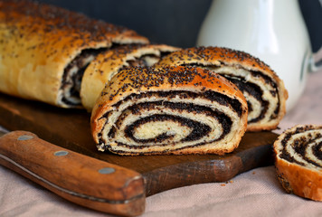 Homemade roll with poppy seeds and milk for breakfast