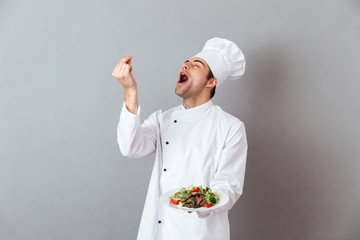 Portrait of a happy male chef dressed in uniform