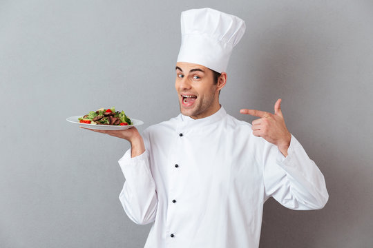 Portrait of a happy male chef dressed in uniform