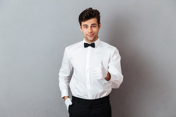 Portrait of a smiling young male waiter