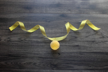 Golden ribbon with yellow ball