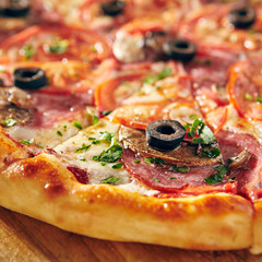 Pizza Restaurant Menu - Delicious Fresh Pizza with Sausages, Tomatoes and Mushrooms.Pizza on Rustic Wooden Table with Ingredients