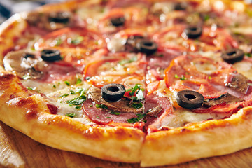 Pizza Restaurant Menu - Delicious Fresh Pizza with Sausages, Tomatoes and Mushrooms.Pizza on Rustic Wooden Table with Ingredients