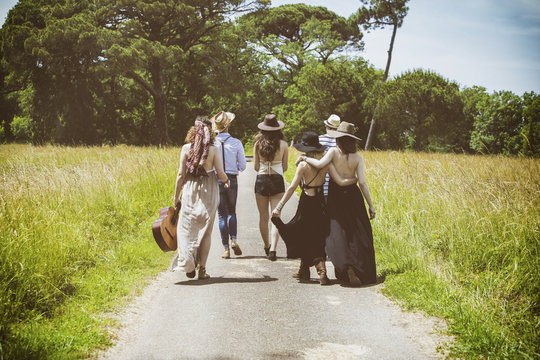 Youth group Hipster back, walking on the country road