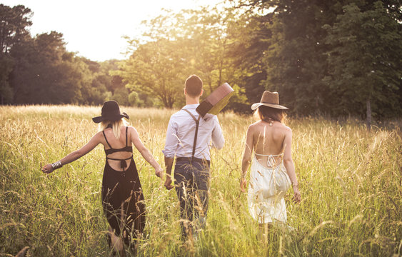 Youth group Hipster, back, ride in a field