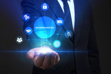 Fototapeta premium Business, Technology, Internet and network concept. Young businessman working on a virtual screen of the future and sees the inscription: Recommendation