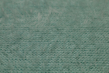 Texture of a fragment of a warm winter female soft fluffy blue sweater