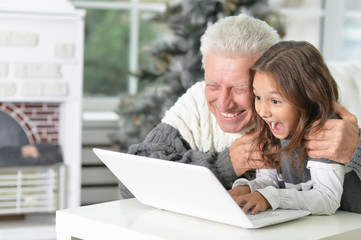 Grandfather and child with laptop