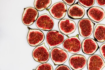 Pattern of sliced ripe figs isolated on white background. Fruit illustration. Food photo. Flat lay, Top view.