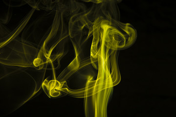 Yellow smoke on black background