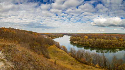 Autumn landscape on the hills of the River Don. View of the pond on a background of cloudy sky ..