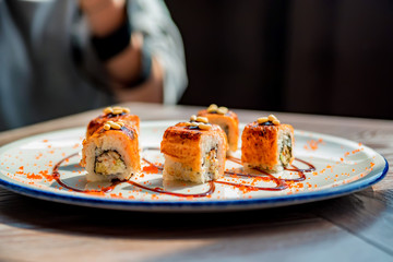 Food photographer takes picure of sushi rolls