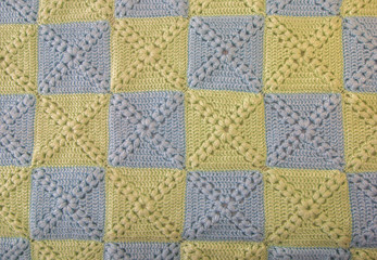  Knitted handmade colourful blankets blue and green, gentle colors. Colorful original knitted handmade work. Crochet stitches. Rustic background