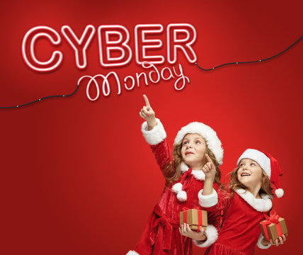 The little girls in Santa hat with gifts