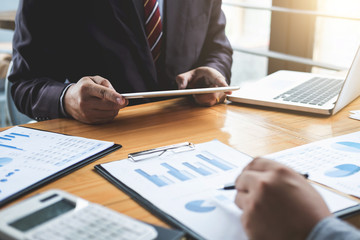 Co working conference, Business team meeting present, investor colleagues discussing new plan financial graph data on office table with laptop and calculator, Finance, accounting, investment