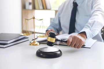 Judge gavel with scales of justice, male lawyers working having at law firm in office. Concepts of law