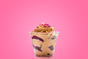 sweet dessert with cream on a pink background
