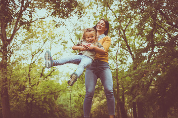 Mother playing with daughter. On the move.