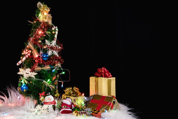 Christmas holiday background with decorated christmas tree, santa claus and gift boxes on black background. New Year Frame for your text