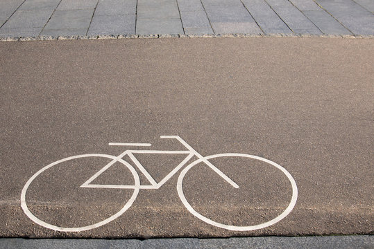 Bicycle white sign or icon on the asphalt road in the city