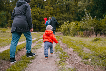 mother walk with son in the autumn park