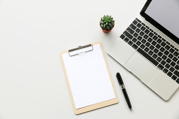 Office table with Laptop computer,pen,Clipboard and cactus, copy space,Top view, flat lay
