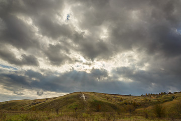 Autumn landscape in central Russia. Cloudy sky over the hills.