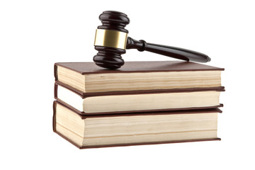 Wooden hammer on a pile of books isolated on a white background