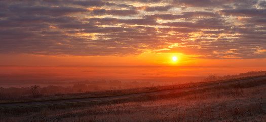 Panoramic landscape with fog in the background of the rising sun.