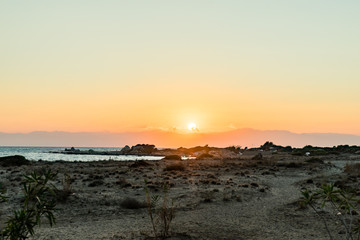 sunset over a large sandy beach