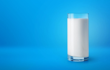 Glass of milk on blue background