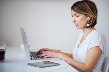 Freelancer using laptop for work while sitting in home office