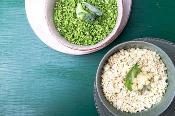 Cauliflower rice and broccoli rice in bowl on green background. Top view. Overhead. Copy space....