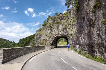 France, Col de la Schlucht: Cyclist in front of road tunnel in rock mountains
