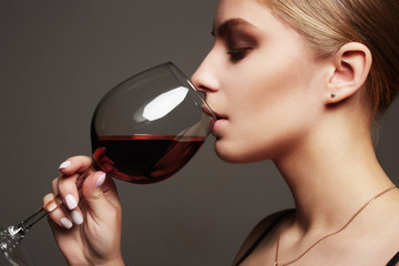 Beautiful blond woman with red wine