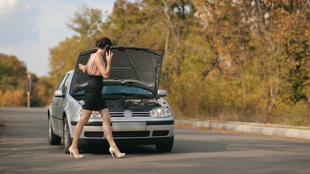 Sexy womam with broken car on the road