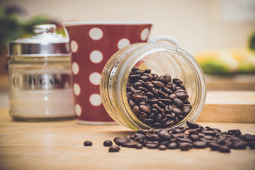 Coffee beans have been spilled out of a jar