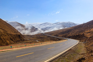 Beautiful winter road in Tibet under snow mountain, Sichuan, China