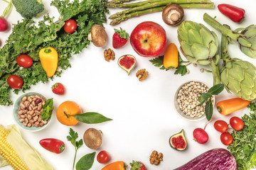 Vibrant fresh vegetables, fruits, and legumes on white