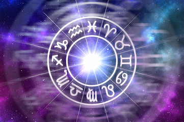 Zodiac signs inside of horoscope circle on universe background