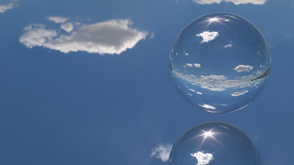 Close up view of one sphere and mirror ground reflecting blue sky and white clouds. 3d generated background.