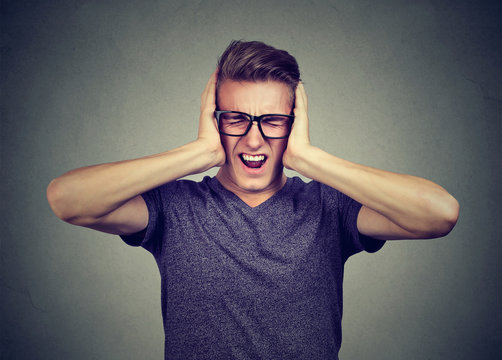 stressed man frustrated can't tolerate anymore loud noise. Negative human emotions 