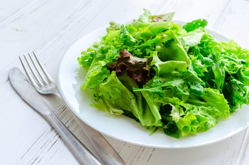 Lettuce salad mix on a wooden table