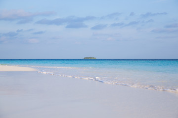 tropical island in clear blue sea