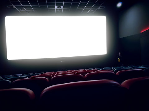 cinema interior of movie theatre with empty red seats with copyspace on the screen and glow on edge, concept of recreation and entertainment