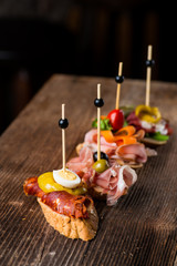 Tapas on Crusty Bread - Selection of Spanish tapas served on a sliced baguette.