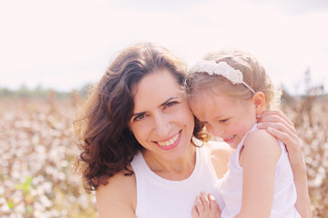 Portrait of beautiful mother with daughter outdoors