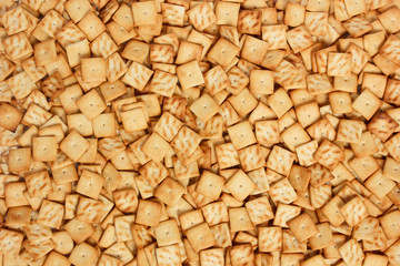 A background consisting of a bunch of mini saltine crackers.