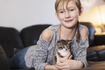 10 years old girl with kitten at home