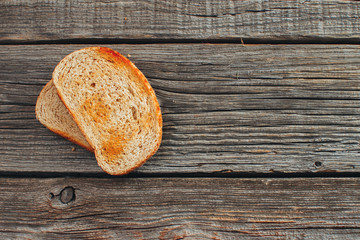 On wooden background, on the boards of toasted bread